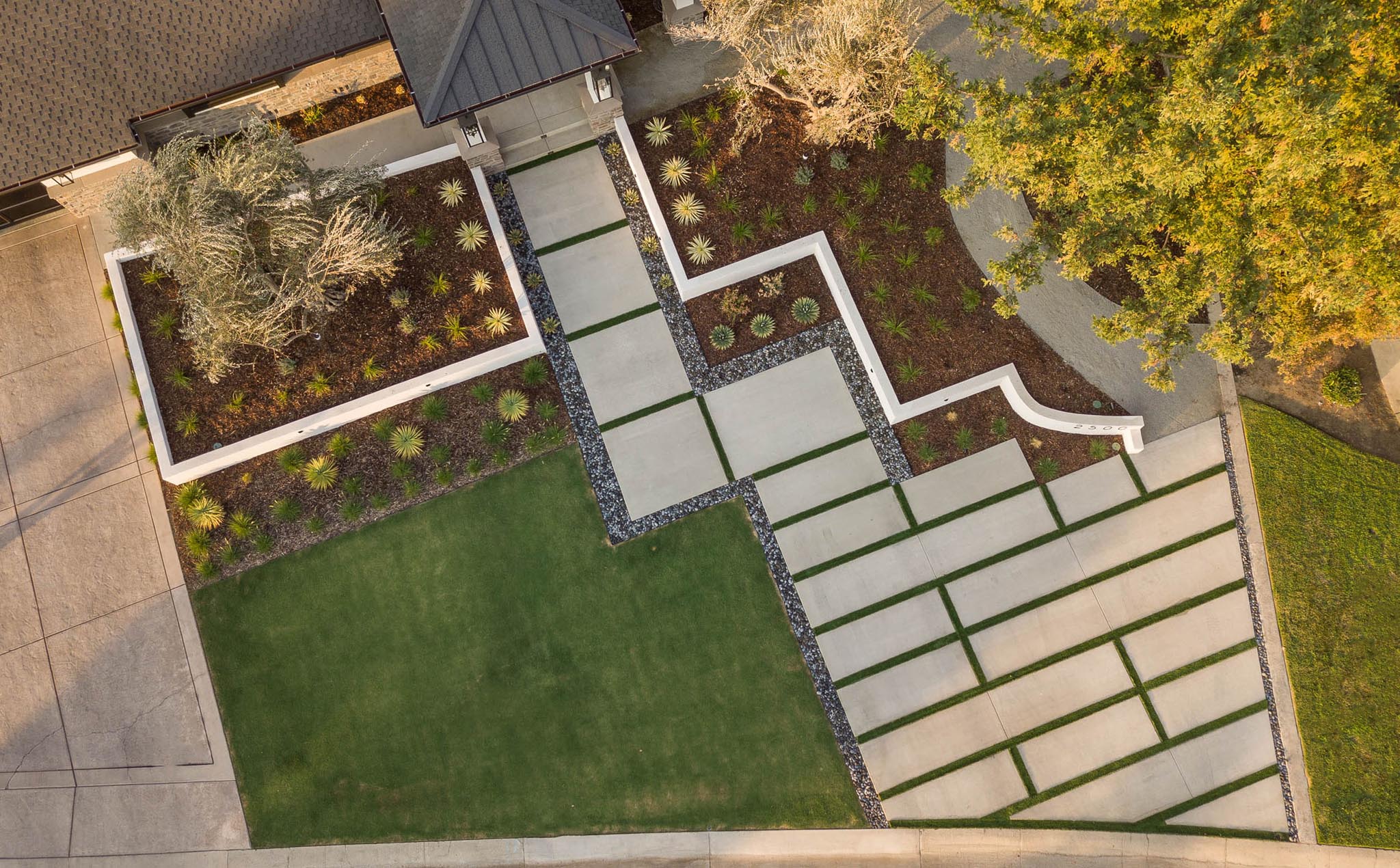 Aerial view of a landscaped yard with pathways and greenery